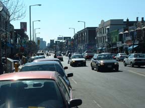 Danforth Avenue, Toronto, West of Pape Ave, midday, midweek, midwinter. Can you see the three jaywalkers? Sure you can.